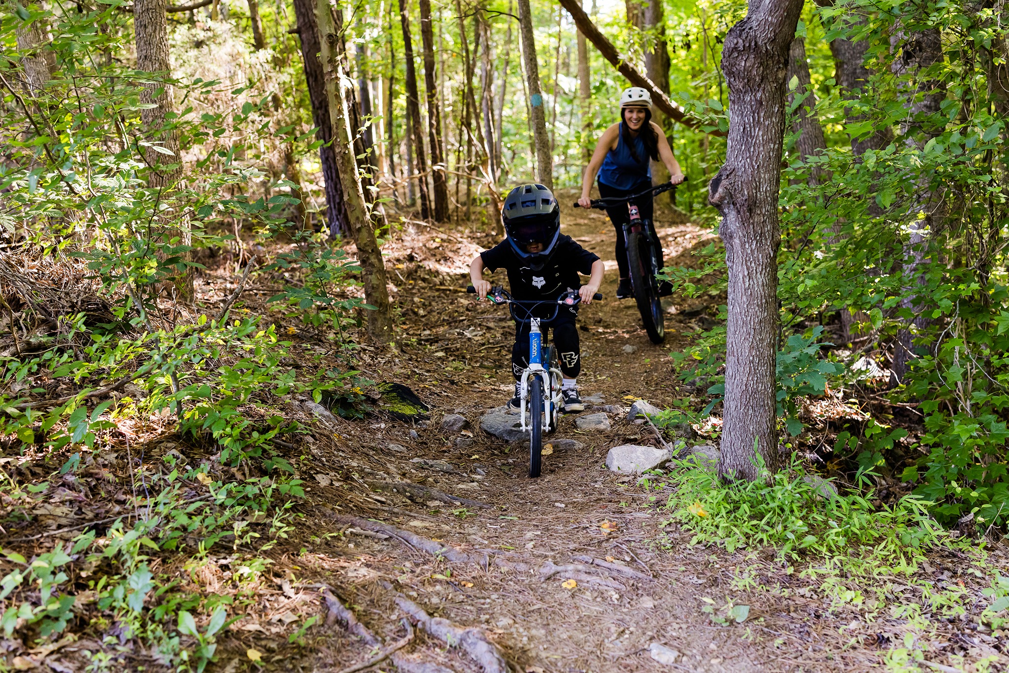 mom and son mountain biking in Raleigh, NC during family bike ride.